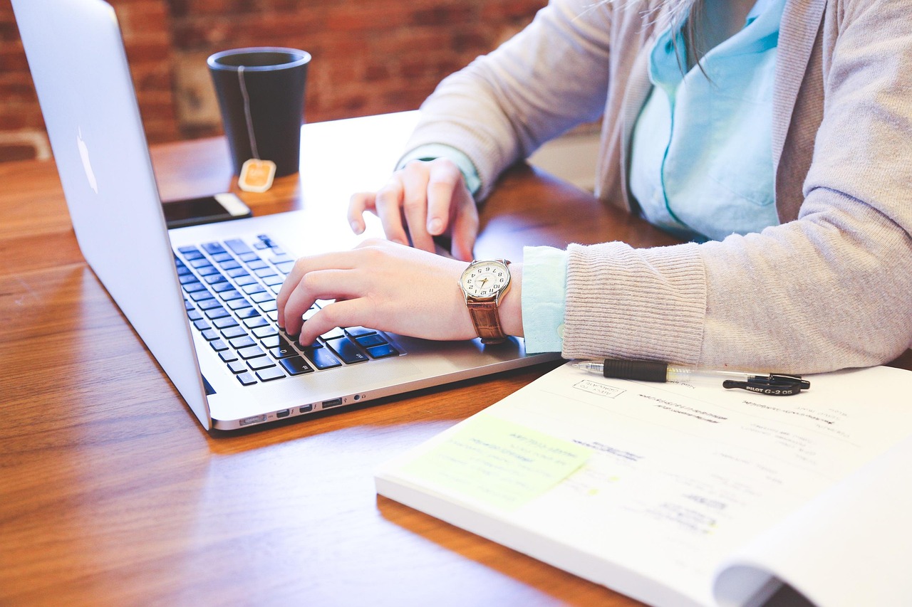 Person typing on laptop at desk